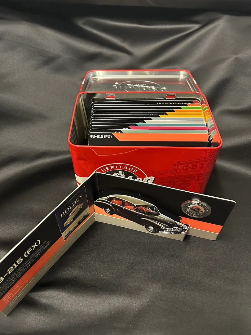 Lot 47 — 2016 Holden Heritage Collectors Tin - 12x 50c Coin Collection (*Tin Damaged*, Coins Perfect)